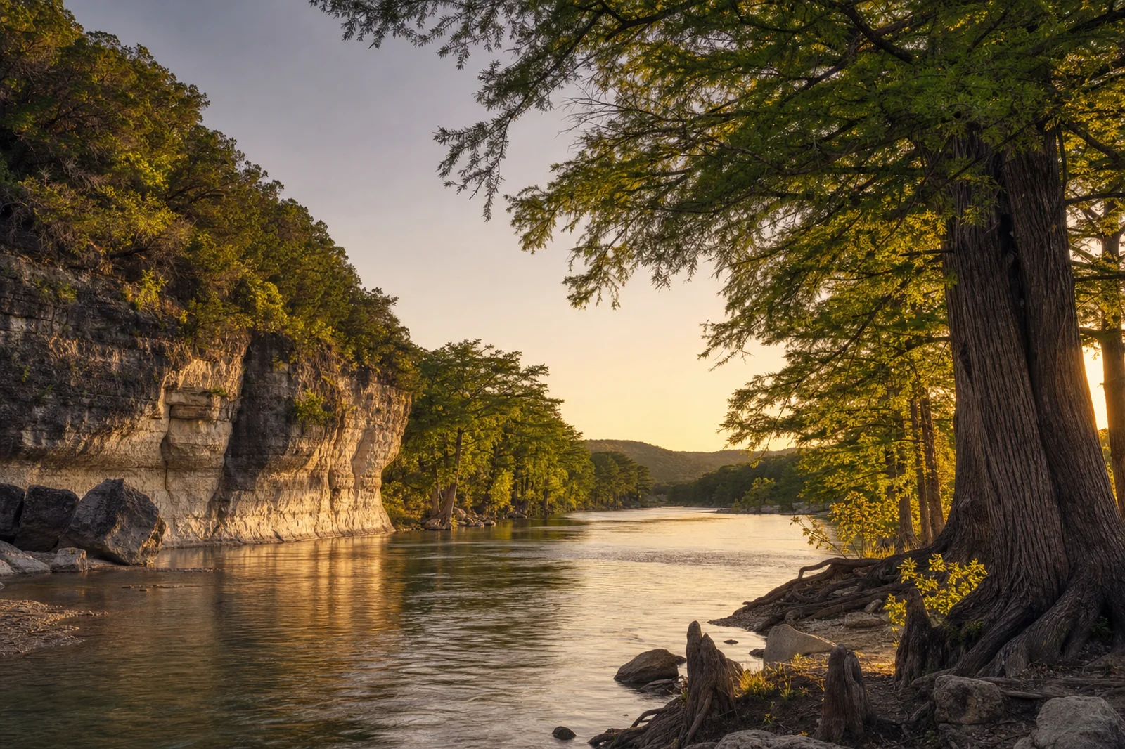 Kerrville, Texas — Guadalupe River at golden hour with cypress trees along limestone banks and rolling Hill Country horizon